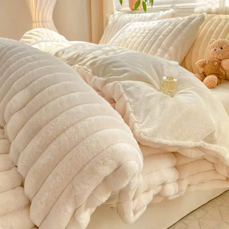 The Hotham quilt cover is a soft, creamy white shade with a luxurious, velvety texture. The edges are bordered with a plush, fluffy trim that adds depth and enhances its inviting appearance. Overall, it exudes warmth and comfort, perfect for a serene, restful bedroom setting. Due to the neutral tones of this cover it can be paired with so many warm coloured decor and linen choices.
the Hotham queen Size Quilt cover set comes with two matching pillow cases and a matching sheet.